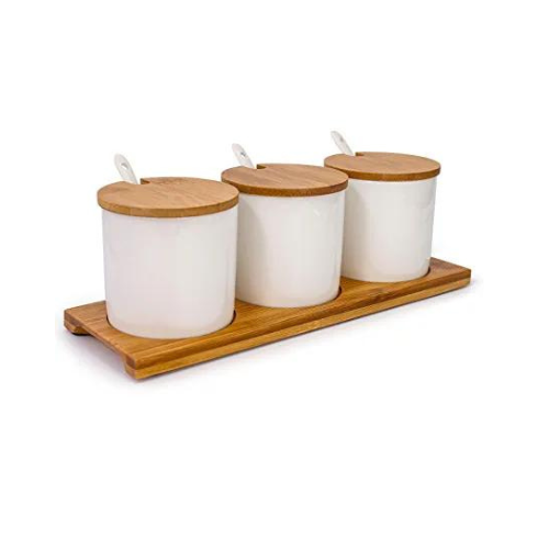 Spices set with spoons and natural wood stand