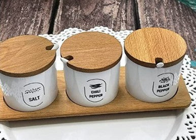 Spices set with spoons and natural wood stand